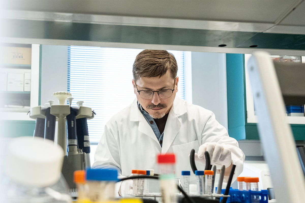 Researcher in lab setting.