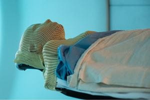 Patient on table wearing facial covering