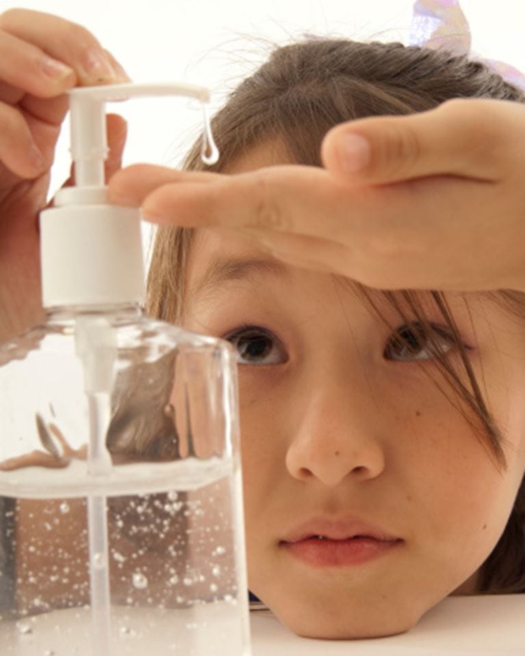 Child pumping hand sanitizer