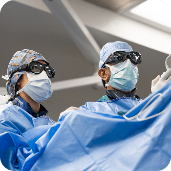 Doctor and nurse wearing masks during procedure.